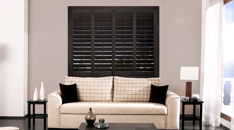 Chicago sunroom with stained wood shutters.